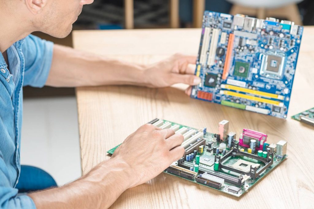 it-technician-upgrading-motherboard-wooden-table