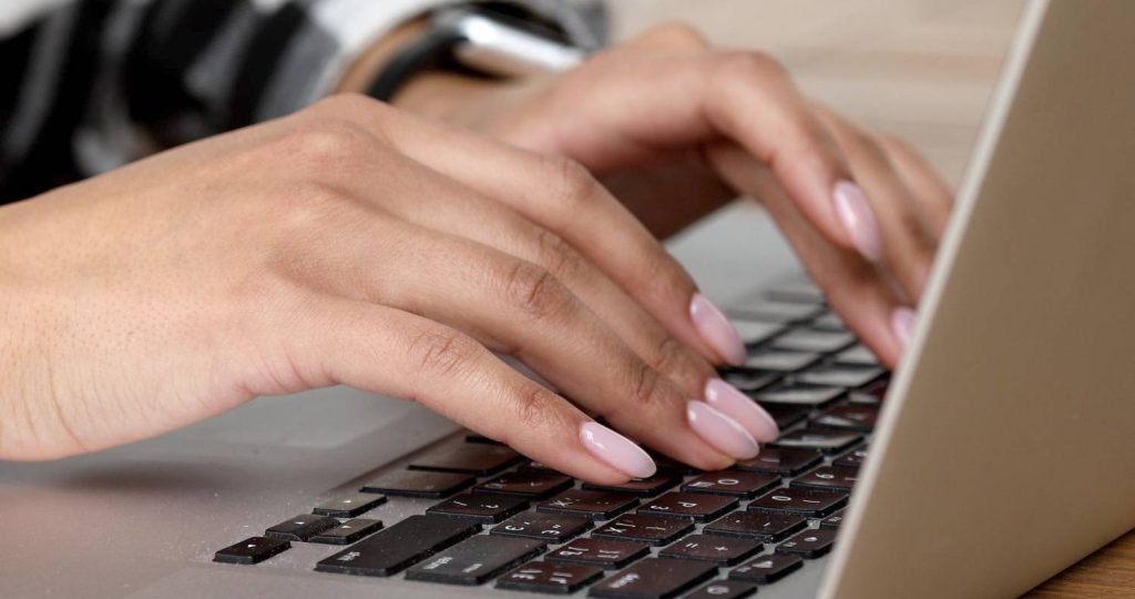 woman-working-home-office-hand-keyboard-close-up